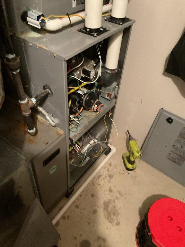 Responded to service call regarding humidifier malfunction following previous technician visit. Upon inspection, accessed furnace cabinet and examined humidifier system components including water supply lines, humidifier pad, and electrical connections. Humidifier pad appeared to be in serviceable condition within its black mounting frame. Verified proper installation of evaporator pad and checked water supply plumbing connections. Documented system configuration and current state of equipment for service records.