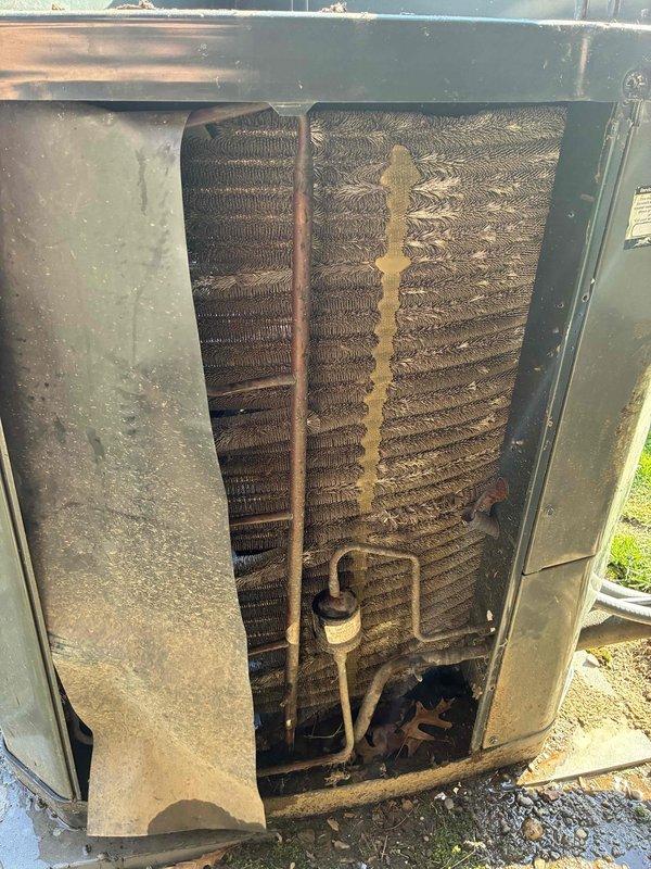 Completed MVP recurring cooling maintenance visit on residential HVAC system. Upon inspection, found outdoor condenser unit with heavily soiled coil fins showing significant dirt, grime, and debris accumulation affecting airflow and system efficiency. Documented condenser coil condition showing dark brownish-black buildup and yellowish-brown staining on coil surfaces. Inspected copper refrigerant lines and found normal weathering consistent with outdoor exposure. Examined blower wheel assembly and verified clean condition with proper blade spacing and mounting. Unit cabinet showed typical weathering and surface corrosion from outdoor elements. Captured photographic documentation of equipment condition for service records. Contacted customer prior to arrival as requested.