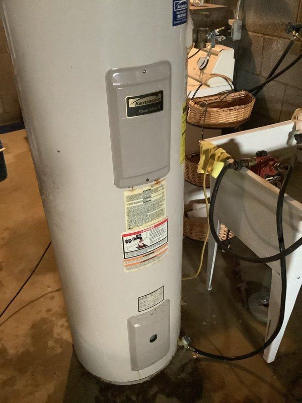 Replaced failed 40-gallon electric water heater in basement due to active leaking that caused significant water damage to concrete floor. Removed existing Kenmore unit and installed new 40-gallon electric water heater with required expansion tank to prevent future pressure-related issues. Connected all electrical and plumbing connections per code, tested unit for proper operation, and verified no leaks at installation points.