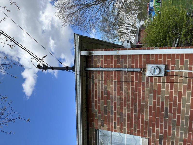 Conducted site evaluation for electric vehicle charging station installation at residential brick building. Assessed existing electrical service and meter location on exterior wall, documented current electrical infrastructure including conduit routing and utility connections. Photographed building exterior, electrical meter box, and proposed installation pathway to determine optimal charger placement and required materials. Evaluated electrical panel capacity and distance from meter to proposed charging location. Prepared comprehensive estimate for EVSE installation including necessary electrical upgrades, conduit runs, and dedicated circuit requirements to support Level 2 charging equipment.