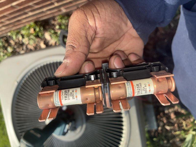 Completed promotional A/C tune-up service on residential cooling system. Connected manifold gauges to service ports to verify refrigerant pressures and system operation. Inspected and removed electrical fuses from disconnect box for examination, confirming proper amperage rating and blade condition before reinstallation. All components found operating within normal parameters upon completion of tune-up procedures.