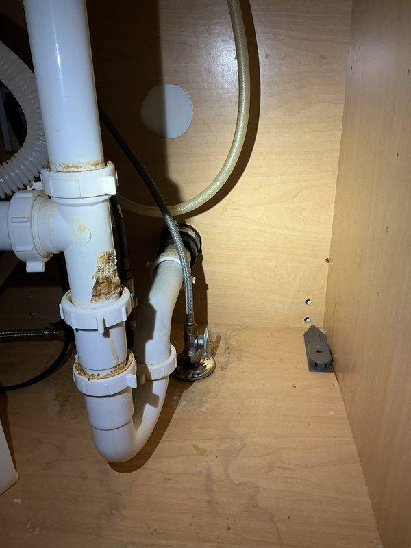 Conducted on-site assessment for installation of Aquasana reverse osmosis water filtration system under kitchen sink. Inspected existing under-sink plumbing configuration, including PVC P-trap assembly, flexible water supply lines, and cabinet space. Observed existing drain connections showing signs of mineral deposits and water staining around threaded couplings. Evaluated basement utility routing to determine optimal water supply line connection point and drain line integration for RO system waste water discharge. Assessed cabinet dimensions and existing plumbing layout to confirm adequate clearance for filtration unit, storage tank, and dedicated faucet installation. Provided comprehensive estimate for complete reverse osmosis system installation including all necessary fittings, supply line connections, and drain saddle valve.