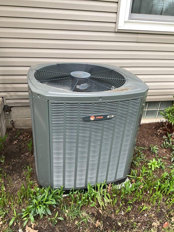 Completed preventive maintenance visit on Trane condensing unit at residential property. Performed standard cooling system inspection including visual assessment of outdoor unit condition, verified proper clearances around equipment, and documented unit operation. Unit appeared functional with normal wear consistent with outdoor installation, surrounded by adequate airflow space despite minor vegetation growth at base requiring future monitoring.