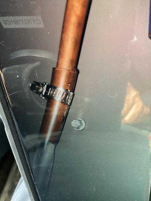 Responded to service call for newly installed furnace with water leakage from side panel. Inspected unit and identified condensate drainage issue, secured copper condensate line with proper hose clamp, and verified drain valve operation. Adjusted air filter access panel to eliminate obstruction that was preventing easy filter removal and replacement.