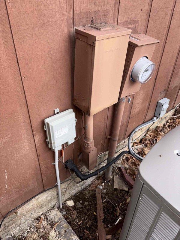 Conducted comprehensive site assessment of residential property following catastrophic flood damage. Property had been gutted by mitigation company with complete removal of interior finishes down to wall studs and subfloor. Evaluated requirements for full HVAC system replacement, electrical rewiring, and hot water heater installation. Documented existing exterior utility connections and deteriorated equipment mounting locations on building exterior. Assessed ductwork replacement needs throughout structure. Coordinated entry access through garage door as primary entrance point during evaluation phase.