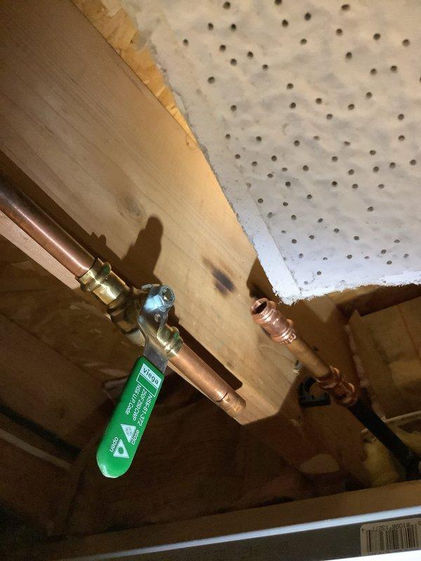 Responded to exterior spigot failure where ball valve had separated from the faucet body. Due to repeated disconnection issues and non-functional crimping equipment, soldered the ball valve directly to the exterior faucet assembly to provide a permanent, leak-proof connection. Replaced failed compression fittings with soldered copper joints on the water supply line to ensure long-term reliability and prevent future separation of components.