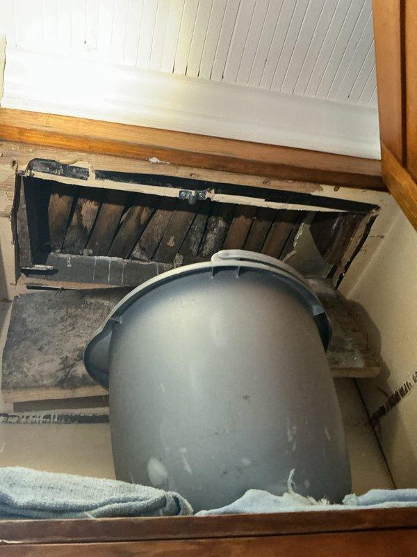 Responded to water leak originating from bathtub drain and penetrating through floor into kitchen below. Upon inspection, confirmed no existing access panel available for direct access to drain assembly. Assessed leak source through floor register opening and basement area, documenting conditions of affected plumbing system and surrounding structure for repair planning.