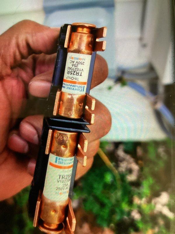Completed routine MVP cooling maintenance visit on HVAC system. Inspected and replaced two 250V AC electrical fuses (TR25 V102M rated) that showed signs of oxidation on copper terminals. Evaluated air filter condition within air handler unit, noting accumulation of dust and particulate matter on pleated media. Verified proper filter installation and system access panel integrity. Documented equipment condition through photographic records for maintenance history. All electrical connections and safety components inspected and confirmed operational following fuse replacement.
