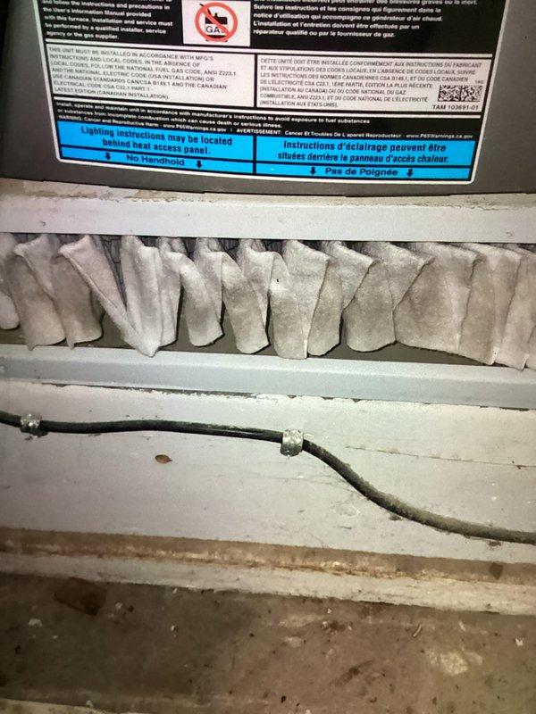 Completed routine MVP cooling maintenance visit on HVAC system. Inspected and replaced two 250V AC electrical fuses (TR25 V102M rated) that showed signs of oxidation on copper terminals. Evaluated air filter condition within air handler unit, noting accumulation of dust and particulate matter on pleated media. Verified proper filter installation and system access panel integrity. Documented equipment condition through photographic records for maintenance history. All electrical connections and safety components inspected and confirmed operational following fuse replacement.