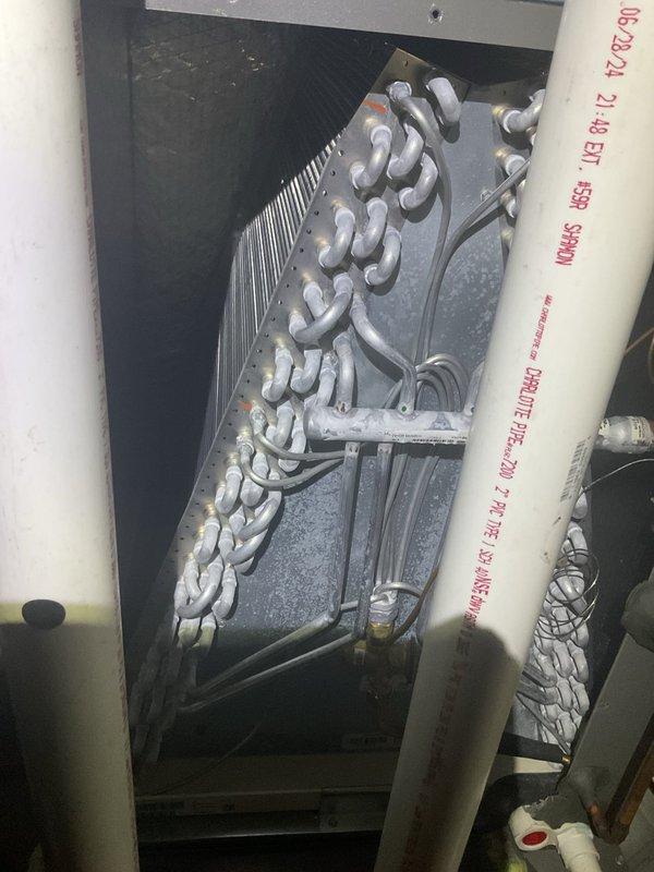 Completed annual AC maintenance tune-up to maintain warranty compliance. Inspected evaporator coil assembly showing normal dust accumulation and verified proper refrigerant line connections. Documented heavily soiled condenser coil with significant dirt and debris buildup restricting airflow through aluminum fins; unit requires professional coil cleaning to restore optimal heat transfer efficiency and system performance.