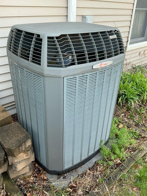 Conducted on-site assessment for complete HVAC system replacement of 17-year-old furnace and air conditioning unit. Evaluated existing Trane outdoor condenser positioned on concrete pad against exterior wall, documented current equipment condition through photos, and prepared site layout measurements for new equipment installation and service access requirements.