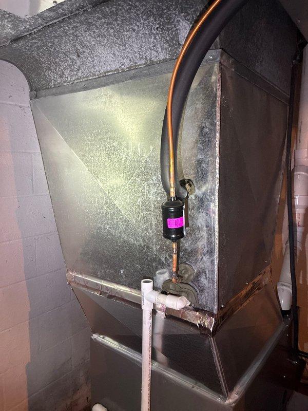 Completed scheduled MVP cooling maintenance visit on residential HVAC system. Performed comprehensive inspection of both indoor air handler unit and outdoor Lennox condensing unit. Indoor unit showed significant condensation accumulation on cabinet surfaces, indicating proper cooling operation and adequate airflow. Verified refrigerant lines, inspected inline filter drier with identification tag, and confirmed condensate drain system functioning correctly with visible PVC drainage. Outdoor condenser unit inspected for proper operation, clearance from debris, and secure mounting on isolation pads. Confirmed refrigerant line insulation intact and all mechanical components operating within normal parameters. System operating efficiently with no deficiencies noted.