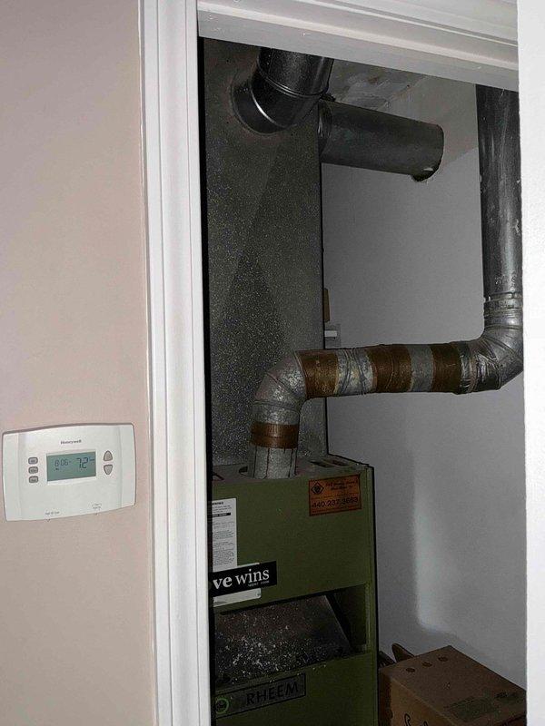 Completed on-site evaluation for furnace and air conditioning system replacement. Assessed existing HVAC equipment including green furnace unit with aged ductwork showing rust and discoloration, and dark Rheem air handler in utility closet. Documented current system configuration, photographed equipment condition, and prepared comprehensive replacement estimate for new furnace and AC system under promotional offer.