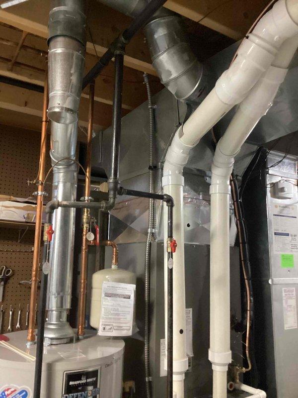 Completed scheduled MVP cooling maintenance visit on residential HVAC system. Performed comprehensive inspection of Lennox furnace and associated cooling components, including ductwork, refrigerant lines, and electrical connections. Verified proper operation of all safety controls, checked condensate drainage system with white PVC piping, and inspected Bradford White water heater integration with HVAC system. All equipment found operating within normal parameters with no issues identified.