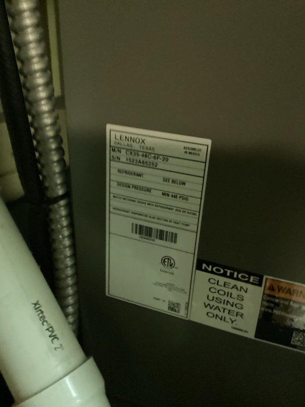 Completed preventive maintenance on Lennox model CKH-48C-BF-20 air conditioning system. Inspected evaporator coil and found heavy accumulation of dust and debris on mesh screen, particularly concentrated on one side. Documented equipment condition with manufacturer nameplate showing serial number 1522AM2942 and refrigerant specifications. System operational upon completion of maintenance visit.