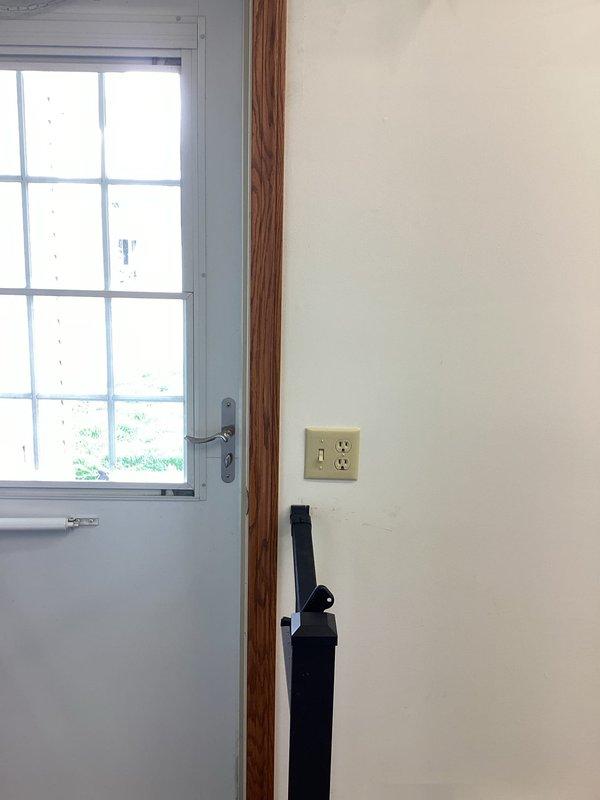 Provided free second opinion electrical estimate for installation of exterior electrical outlet on outside porch. Assessed existing electrical infrastructure in adjacent utility room and evaluated potential circuit routing through exterior wall near door with window panel. Documented current conditions including proximity to existing interior outlet and switch combination, confirmed wall construction and access points, and photographed site conditions to develop accurate scope of work for outdoor receptacle installation with appropriate weatherproof enclosure and GFCI protection per code requirements.
