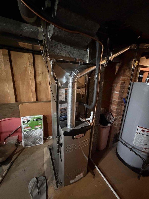 Completed installation of outdoor condensing unit as part of previously scheduled winter AC system installation. Replaced dual fuses in exterior disconnect box and verified proper electrical connections. Confirmed all refrigerant lines, electrical wiring, and condensate drainage properly connected between indoor furnace coil and outdoor condenser unit, with system now fully operational for cooling season.