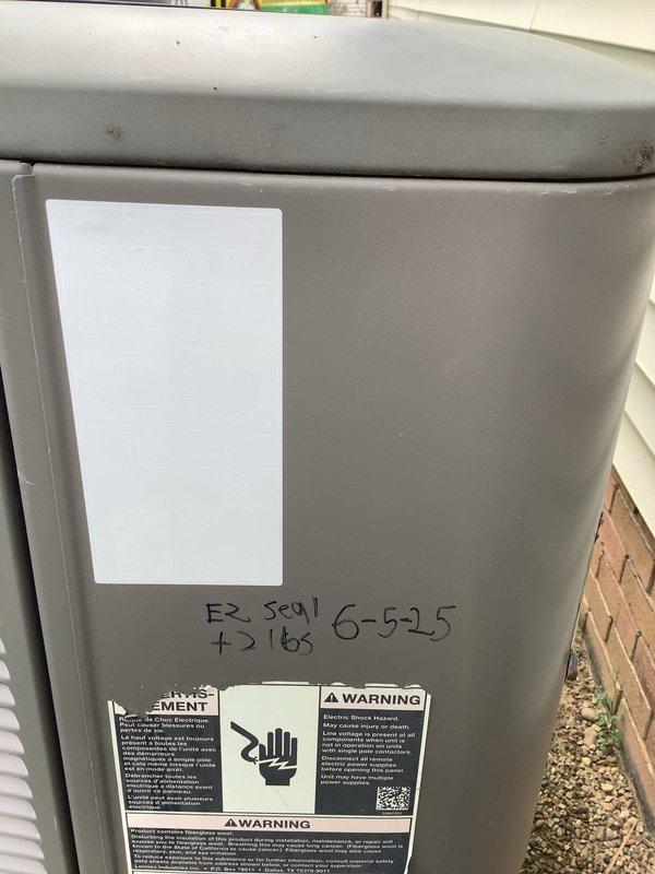 Responded to no cooling complaint on residential split system. Upon arrival, confirmed outdoor condensing unit running but home not reaching setpoint temperature. Inspected outdoor unit and noted handwritten service notation indicating refrigerant addition on 6-5-25. Documented system information and captured unit data plate details. Examined indoor air handler and associated components in basement installation. Contacted Aegis home protection plan to report findings and verify coverage authorization prior to proceeding with diagnostic testing and repairs.