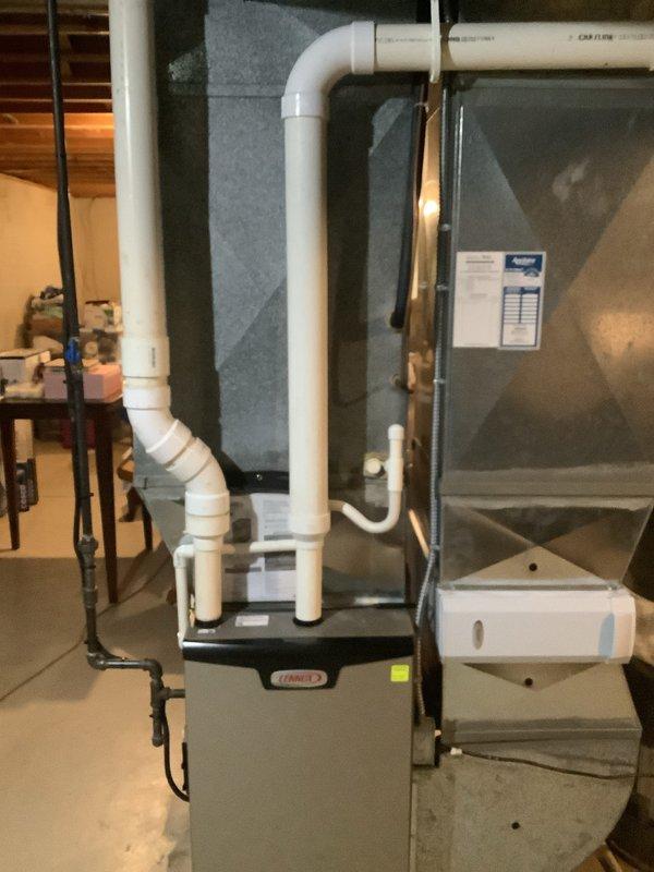 Completed relocation and installation of residential air conditioning system with new evaporator coil. Repositioned outdoor condensing unit to new location with proper gravel base for drainage and equipment stability. Connected new copper refrigerant lines with insulation to indoor air handler, installed condensate drain lines using white PVC piping with proper pitch and trap configuration. Integrated new evaporator coil with existing Lennox furnace system, fabricated and installed sheet metal plenum and ductwork connections to ensure proper airflow distribution. Verified all refrigerant line connections are secure, electrical connections are properly terminated, and condensate drainage is functioning correctly. System tested and operational.