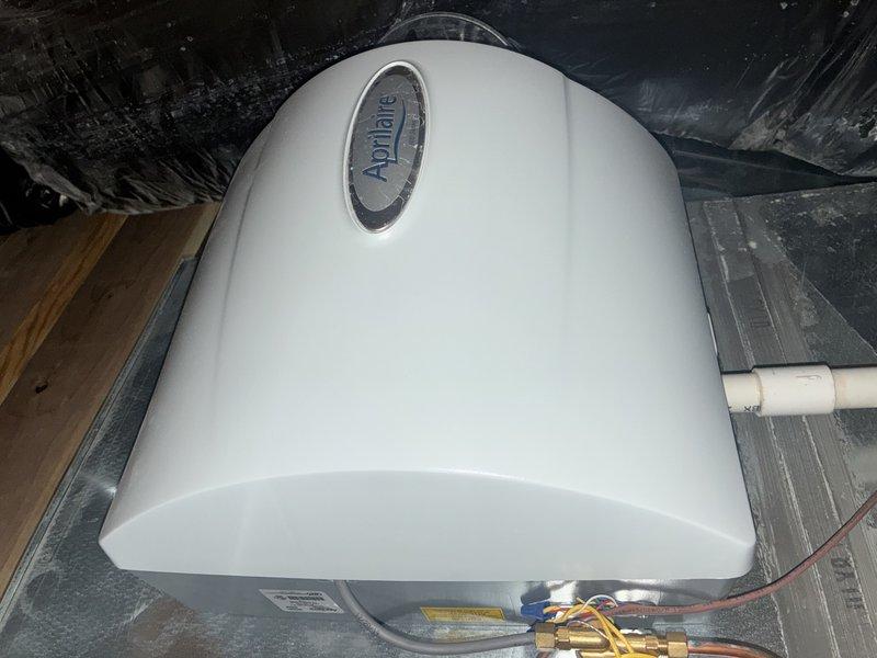 Completed comprehensive heating maintenance inspection on residential HVAC system located in attic space. Serviced and inspected Aprilaire whole-home dehumidification unit, verifying proper operation of all mechanical components, refrigerant lines, and electrical connections. Examined gas valve assembly with SGA416 actuator, checking for proper function and secure mounting on supply line. Verified condensate drainage system with white PVC piping for proper flow and clearance. Inspected copper refrigerant lines, brass fittings, and service valves for signs of leaks or deterioration. All equipment found operating within normal parameters with no immediate service concerns identified.