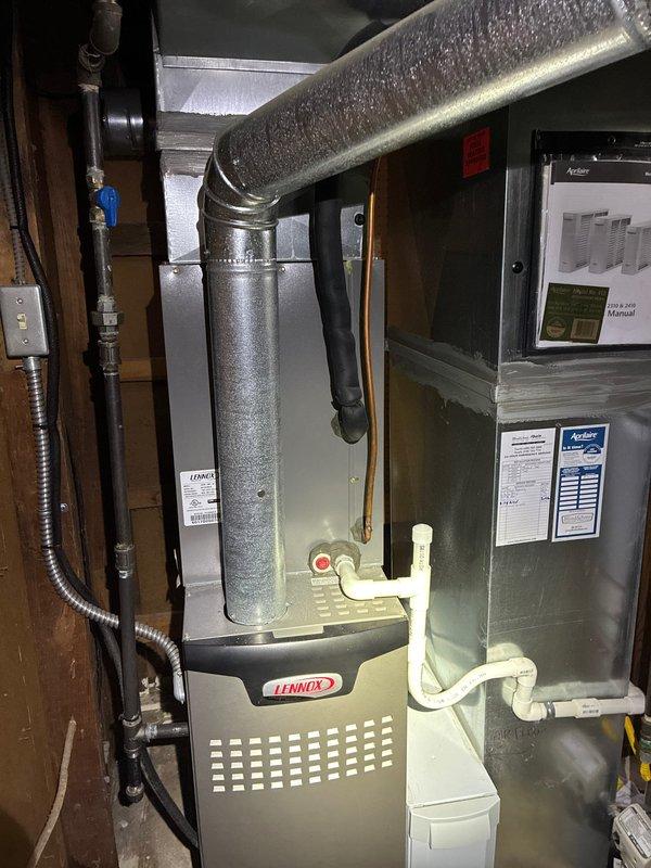Completed MVP cooling maintenance visit on residential Lennox HVAC system. Performed comprehensive inspection of evaporator coil, which showed moderate dust and debris accumulation between fins typical of normal operation. Inspected furnace unit, air handler, flexible ductwork, condensate drain lines, and electrical connections. All system components found to be in good working condition with proper installation standards maintained. Documented equipment condition through photography for service records.