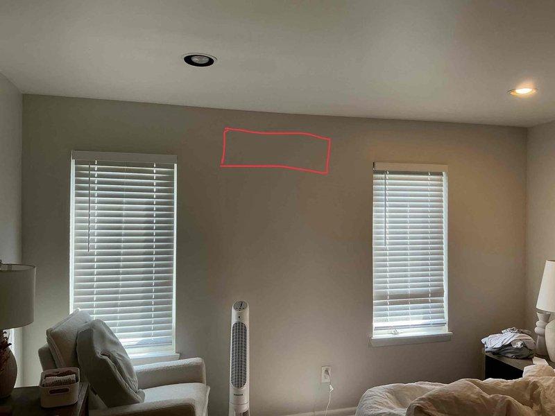 Conducted site evaluation for mini split heat pump installation in bedroom. Assessed proposed indoor unit mounting location on wall between two windows and verified electrical panel capacity and available breaker spaces for new dedicated circuit requirements.