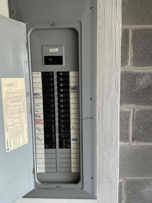 Conducted site evaluation for mini split heat pump installation in bedroom. Assessed proposed indoor unit mounting location on wall between two windows and verified electrical panel capacity and available breaker spaces for new dedicated circuit requirements.