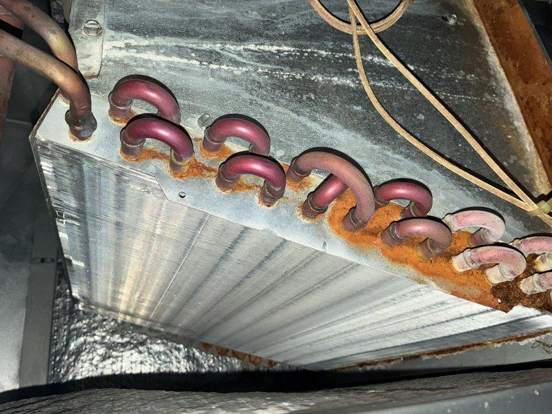 Completed comprehensive AC tune-up on 8-year-old system, including inspection of evaporator coil and blower assembly. Found significant dust accumulation on blower wheel and blades, along with visible corrosion and rust buildup around copper refrigerant line connections at evaporator coil; cleaned components and documented condition with photos for maintenance records. System operational upon completion of preventative maintenance service.