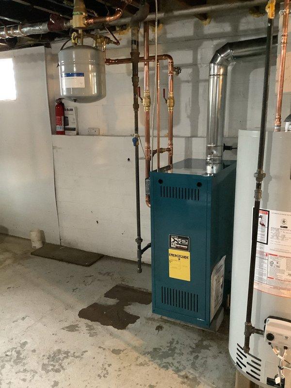 Successfully completed installation of Burnham X204 water boiler system in basement mechanical room. All necessary equipment and components were coordinated for site delivery and staged in advance to ensure efficient installation. The new boiler unit was installed with complete hydronic piping configuration, including copper supply and return lines with brass fittings, circulation pump, shut-off valves, expansion tank connections, and proper venting. All plumbing connections were pressure tested and system was commissioned to manufacturer specifications.