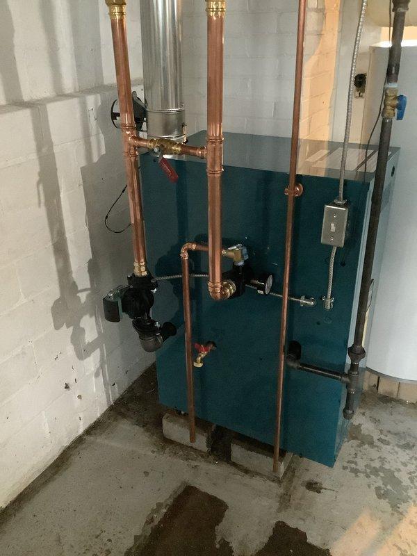 Successfully completed installation of Burnham X204 water boiler system in basement mechanical room. All necessary equipment and components were coordinated for site delivery and staged in advance to ensure efficient installation. The new boiler unit was installed with complete hydronic piping configuration, including copper supply and return lines with brass fittings, circulation pump, shut-off valves, expansion tank connections, and proper venting. All plumbing connections were pressure tested and system was commissioned to manufacturer specifications.