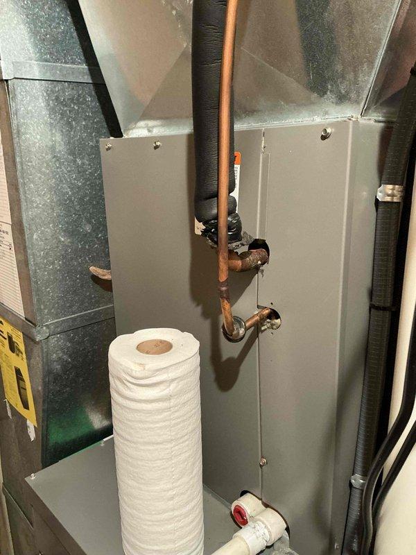 Responded to estimate request for 16-year-old air conditioning system with identified evaporator coil leak. Conducted on-site assessment of existing HVAC installation in mechanical room, documented current system configuration including furnace cabinet, ductwork, refrigerant lines, and associated plumbing components. Provided replacement estimate options for failed coil assembly.