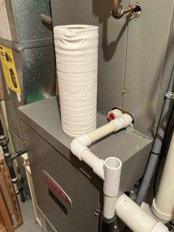 Responded to estimate request for 16-year-old air conditioning system with identified evaporator coil leak. Conducted on-site assessment of existing HVAC installation in mechanical room, documented current system configuration including furnace cabinet, ductwork, refrigerant lines, and associated plumbing components. Provided replacement estimate options for failed coil assembly.