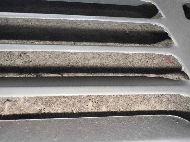 Completed routine air conditioning maintenance on 5-year-old system. Performed comprehensive inspection of electrical connections and terminal blocks, noting significant cobweb accumulation on wiring and control panel components. Cleaned heavily soiled air intake louvers and ventilation slats that showed extensive dust and debris buildup, which was restricting proper airflow. All electrical connections verified secure, system tested and operating within normal parameters upon completion.