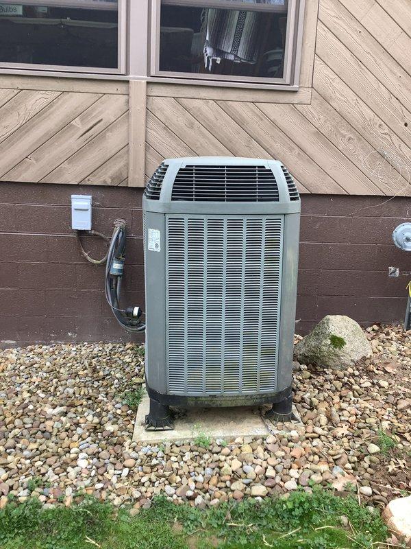 Completed installation of outdoor air conditioning condenser unit and matching evaporator coil as part of a secondary AC system installation. Unit was positioned on concrete pad with proper clearances, secured to manufacturer specifications, and connected to electrical disconnect box via conduit. Refrigerant lines were properly insulated and routed from the outdoor condenser to the indoor coil, with all connections brazed and pressure tested for leaks. System was evacuated, charged with refrigerant to manufacturer specifications, and tested for proper operation including airflow, temperature differential, and electrical draw verification. All installation met local code requirements and manufacturer guidelines for optimal performance.