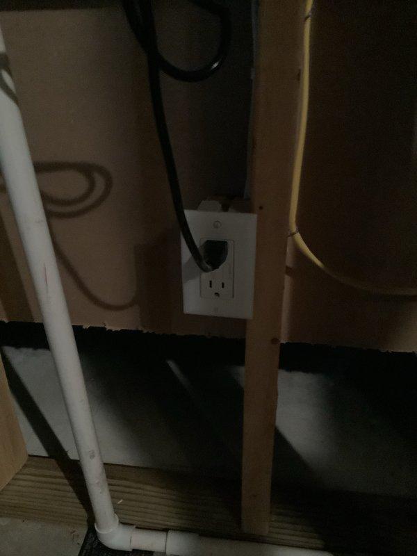 Removed two existing power vent water heater units, expansion tank, and drain pan from the utility area. Installed new Navien tankless water heater system with complete connection of gas supply lines, copper water piping with brass fittings, electrical service, and venting through existing infrastructure. All components properly mounted to wooden framing, system tested and verified operational with Energy Star certified unit displaying normal function on digital interface.