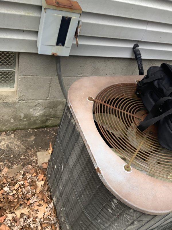 Conducted on-site evaluation for packaged HVAC unit replacement serving a medium-sized residential property with heating and cooling requirements. Assessed existing weathered packaged unit with cylindrical fan assembly, electrical disconnect box, and associated conduit routing along exterior wall. Documented current system configuration, equipment condition showing significant aging and wear, and provided comprehensive replacement estimate for natural gas or propane-fired packaged unit installation.