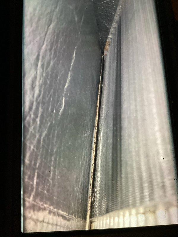 Completed comprehensive air conditioning tune-up on residential HVAC system. Inspected evaporator coil and condenser components, noting minor surface oxidation at coil seam but no performance issues. Verified proper operation of furnace unit, condensate pump, and all associated drainage systems.