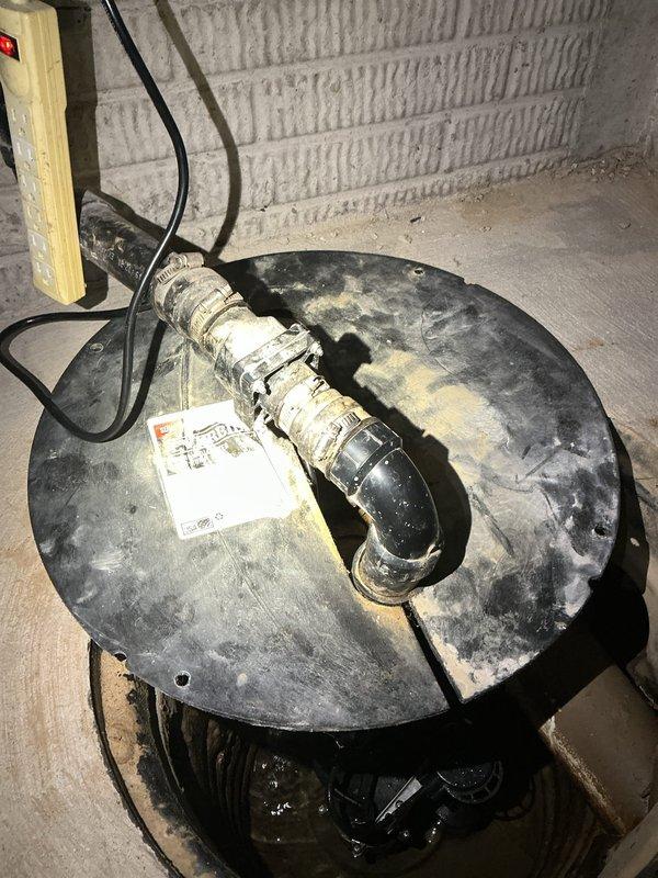 # Sump Pump Noise Evaluation and Consultation

Responded to service call regarding excessive noise from recently installed sump pump system. Performed comprehensive assessment of sump pump assembly, including inspection of pump unit, basin configuration, discharge piping, and mounting setup. Documented existing installation with detailed photographs showing pump positioning within basin, float switch assembly, PVC discharge piping configuration, and overall mechanical setup.

Evaluated potential noise sources including pump vibration against basin walls, improper mounting, discharge pipe resonance, and mechanical operation of float mechanism. Inspected chrome-colored float switch assembly and dark pump housing for proper clearance and secure positioning within corrugated basin. Assessed PVC discharge piping for proper support and potential vibration transmission through rigid connections.

Provided customer with multiple options to reduce operational noise levels, including: installati