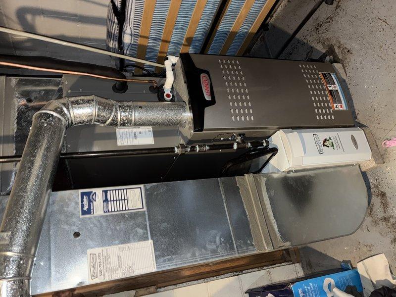 Completed scheduled maintenance visit for MVP customer that had been rescheduled from previous dates. Performed comprehensive cooling system inspection on residential HVAC installation located in basement mechanical room. System consists of gas furnace with connected air handler, humidifier unit, and metallic flex ductwork configuration. 

During inspection, identified significant accumulation of dust, dirt, and debris on system components, particularly on blower assembly and surrounding mechanical parts. Heavy contamination indicated extended period without proper maintenance and presented potential operational efficiency concerns. Documented current system condition through photographic evidence showing equipment layout and contamination levels for service records.

Maintenance procedures focused on restoring system cleanliness and verifying proper operation of all cooling components in preparation for upcoming cooling season.