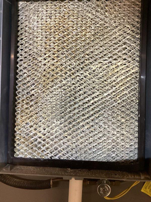 Completed scheduled MVP heating maintenance visit on Lennox furnace system. Inspected and photographed air filter showing moderate dust and debris accumulation with yellowish-brown discoloration throughout the metal mesh construction. Verified all system components including condensate pump, PVC venting, and electrical connections operating within normal parameters. Unit found in good overall condition with no immediate repairs required.