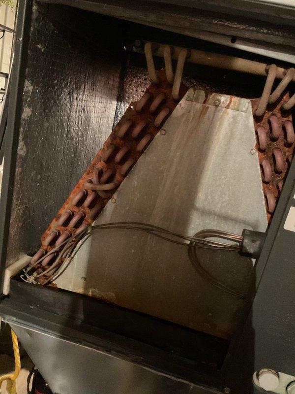 Completed MVP cooling maintenance visit on 12+ year old Lombard furnace system with air handler. Performed standard seasonal inspection and service procedures on aging HVAC equipment. During inspection, identified significant rust and corrosion on evaporator coil copper tubing, indicating advanced deterioration of critical cooling components. Documented extensive oxidation damage throughout serpentine coil sections, which may impact system efficiency and cooling performance. Inspected air handler cabinet, refrigerant line connections, and associated ductwork. All findings photographed and system operational status assessed for customer review and future service planning recommendations.