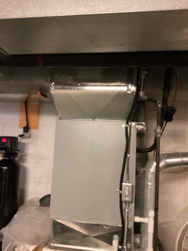 Completed MVP recurring cooling maintenance visit on residential HVAC system located in crawl space/basement area. Performed comprehensive inspection of air handler unit, ductwork, refrigerant lines, and condensate drainage system. All components found operating within normal parameters with appropriate condensation present on supply duct indicating active cooling mode. Verified proper operation of system controls and status indicators. Documented equipment condition through photographic records showing air handler cabinet, insulated refrigerant lines with proper connection caps, PVC condensate drain lines, and sealed ductwork connections.