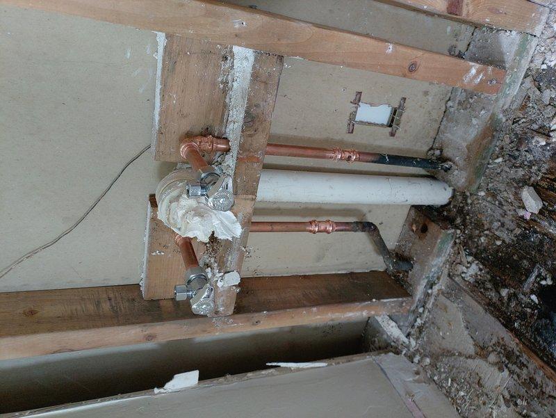 Completed plumbing repair in attic and crawl space areas involving copper pipe installation and replacement. Ordered necessary parts through warehouse with delivery coordination, managing backorder items until all components arrived. Installed new copper piping with proper support straps, hangers, and insulation foam where required, connecting to existing drainage lines and ensuring proper integration with PVC plumbing system and structural framework.