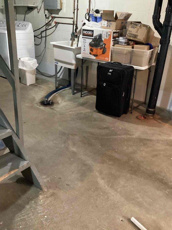 Responded to AC leak at condensate drain line near furnace. Inspected white PVC condensate piping system and identified leak at pipe joint connection showing water staining and discoloration. Repaired defective connection, tested system operation, and verified proper drainage with no further leakage detected.