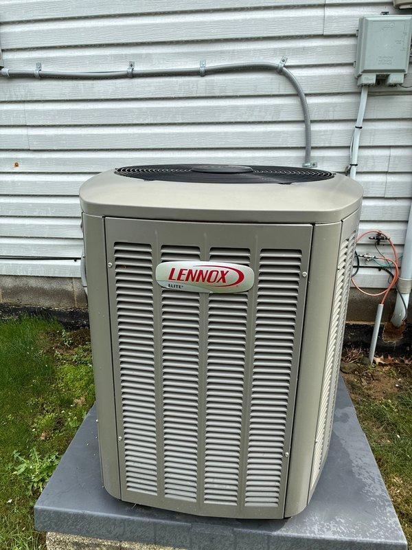Completed MVP cooling maintenance visit on Lennox residential air conditioning system. Upon inspection, discovered severe ice buildup on evaporator coil assembly and refrigerant lines inside air handler unit, indicating restricted airflow or low refrigerant charge. Documented system condition with photos showing frozen copper lines and iced coil fins. Exterior condenser unit operating, properly mounted on concrete pad with electrical connections and refrigerant lines secured. Further diagnostics required to determine root cause of freezing condition and restore proper system operation.