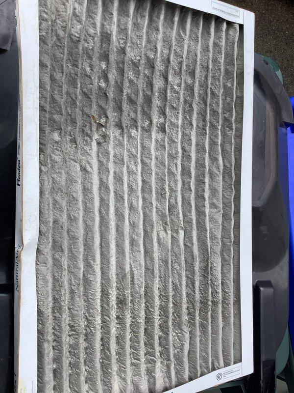 Responded to service call for frozen air conditioning unit at residential property. Upon arrival, found evaporator coil completely iced over, requiring thaw time before diagnostic procedures could be performed. After unit thawed, conducted refrigerant charge assessment and confirmed system was low on refrigerant. Inspected outdoor condensing unit and refrigerant line set for visible signs of leaks or damage. Observed heavily contaminated air filter with significant dust and debris accumulation, which can restrict airflow and contribute to freezing conditions. Provided customer with quote for refrigerant recharge service on older residential system.