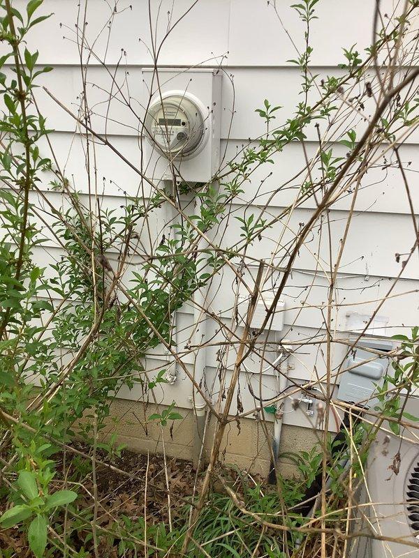 Responded to service call for non-operational electric tankless water heater in 50-year-old residence. Upon arrival, confirmed complete loss of electrical power to the unit. Conducted comprehensive diagnostic assessment of the electrical system, inspecting the main service panel and circuit breaker configuration. Examined interior panel components, including dual-column breaker arrangement, conductor terminations, and neutral/ground bus bar connections. Verified proper wire routing and assessed condition of red, black, and white insulated conductors throughout the distribution panel. Inspected exterior electrical service equipment, including utility meter installation and incoming service connections. Identified and resolved electrical supply issue affecting tankless water heater operation. Restored power to unit and verified proper functionality. Documented electrical panel conditions and exterior service equipment with photographs for service records.