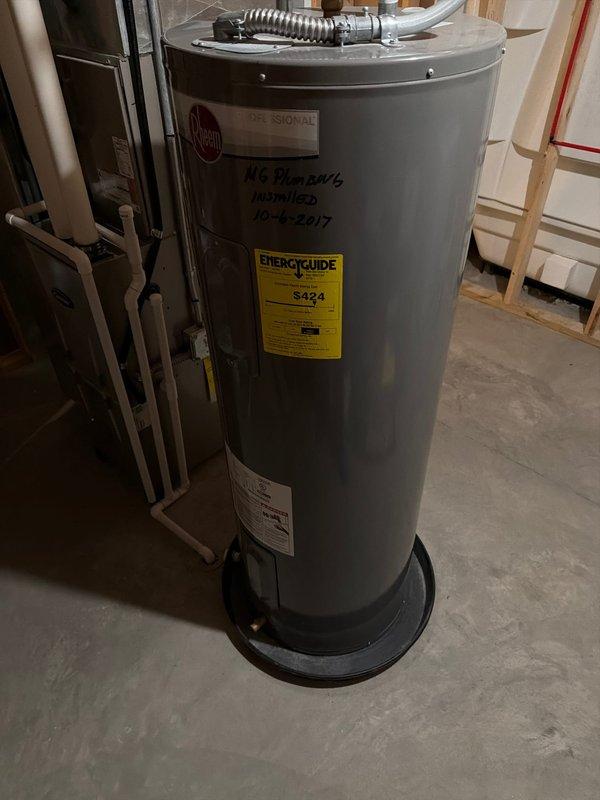 Responded to service call for tanked water heater experiencing rapid hot water depletion. Upon inspection, found residential gas water heater installed in 2017, approximately 7-8 years old at time of service. Assessed unit's overall condition, verified proper venting and plumbing connections including PEX supply lines and brass fittings at top of tank. Documented existing installation with yellow EnergyGuide label showing estimated operating costs. Unit displayed normal wear patterns for age but customer reported insufficient hot water recovery time, indicating potential sediment buildup in tank or failing heating element affecting performance and capacity.