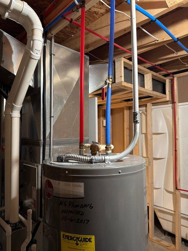 Responded to service call for tanked water heater experiencing rapid hot water depletion. Upon inspection, found residential gas water heater installed in 2017, approximately 7-8 years old at time of service. Assessed unit's overall condition, verified proper venting and plumbing connections including PEX supply lines and brass fittings at top of tank. Documented existing installation with yellow EnergyGuide label showing estimated operating costs. Unit displayed normal wear patterns for age but customer reported insufficient hot water recovery time, indicating potential sediment buildup in tank or failing heating element affecting performance and capacity.