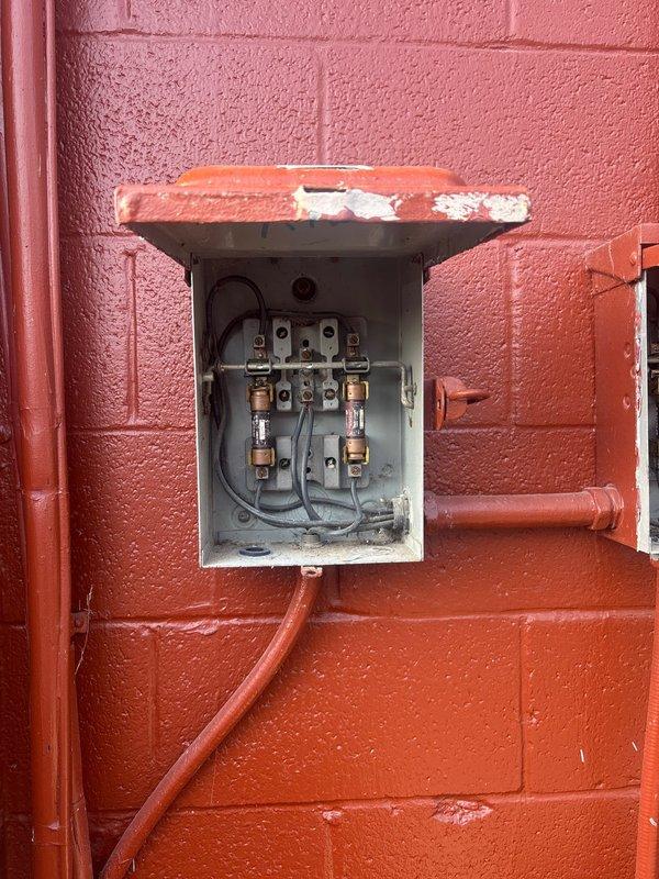 Installed 28kW commercial generator with 200-amp automatic transfer switch to provide backup power for facility. Ran 20 feet of gas line and electrical conduit from main service panel to generator location. Integrated two load shed modules and two soft-start modules for air conditioning units to manage startup loads and prevent system overload during power transfer. Mounted and wired electrical disconnect box on exterior wall with proper conduit routing. Connected generator to existing electrical infrastructure and verified proper operation of all transfer switch functions and load management systems.